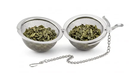 Stainless steel tea infuser ball with chain filled with loose leaf green tea